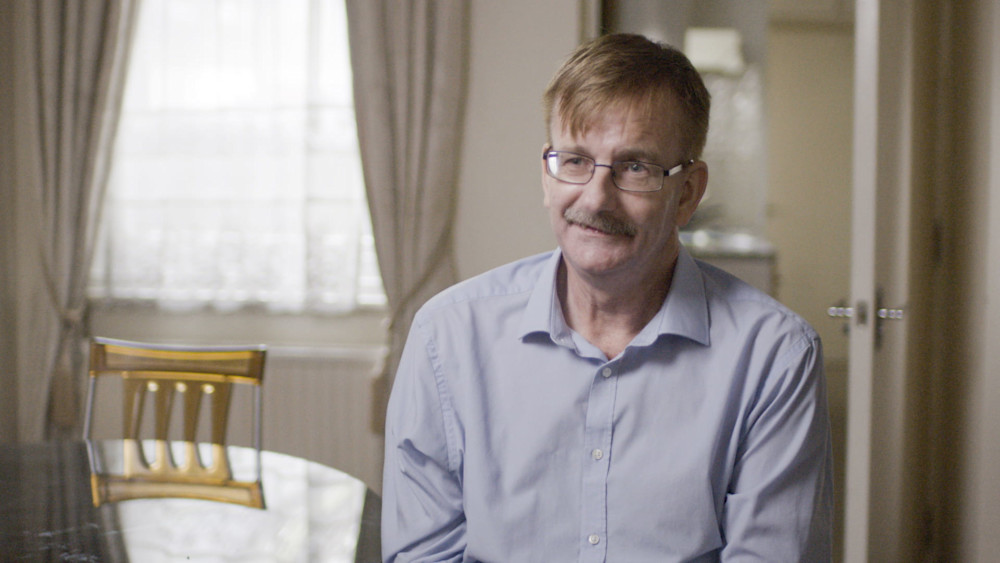 Man with glasses in his home