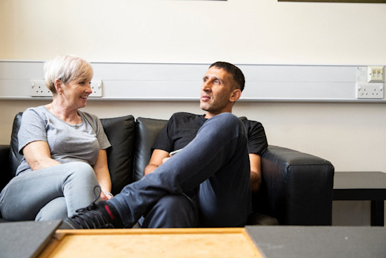Paddy and Collette sitting on a couch chatting
