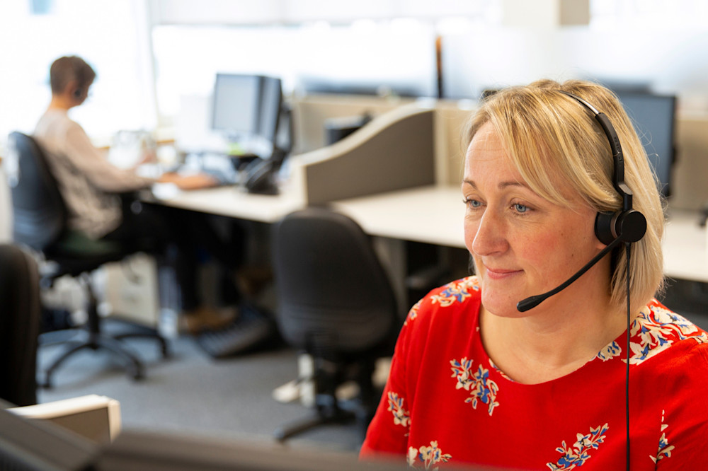 Helpline advisor wearing red top