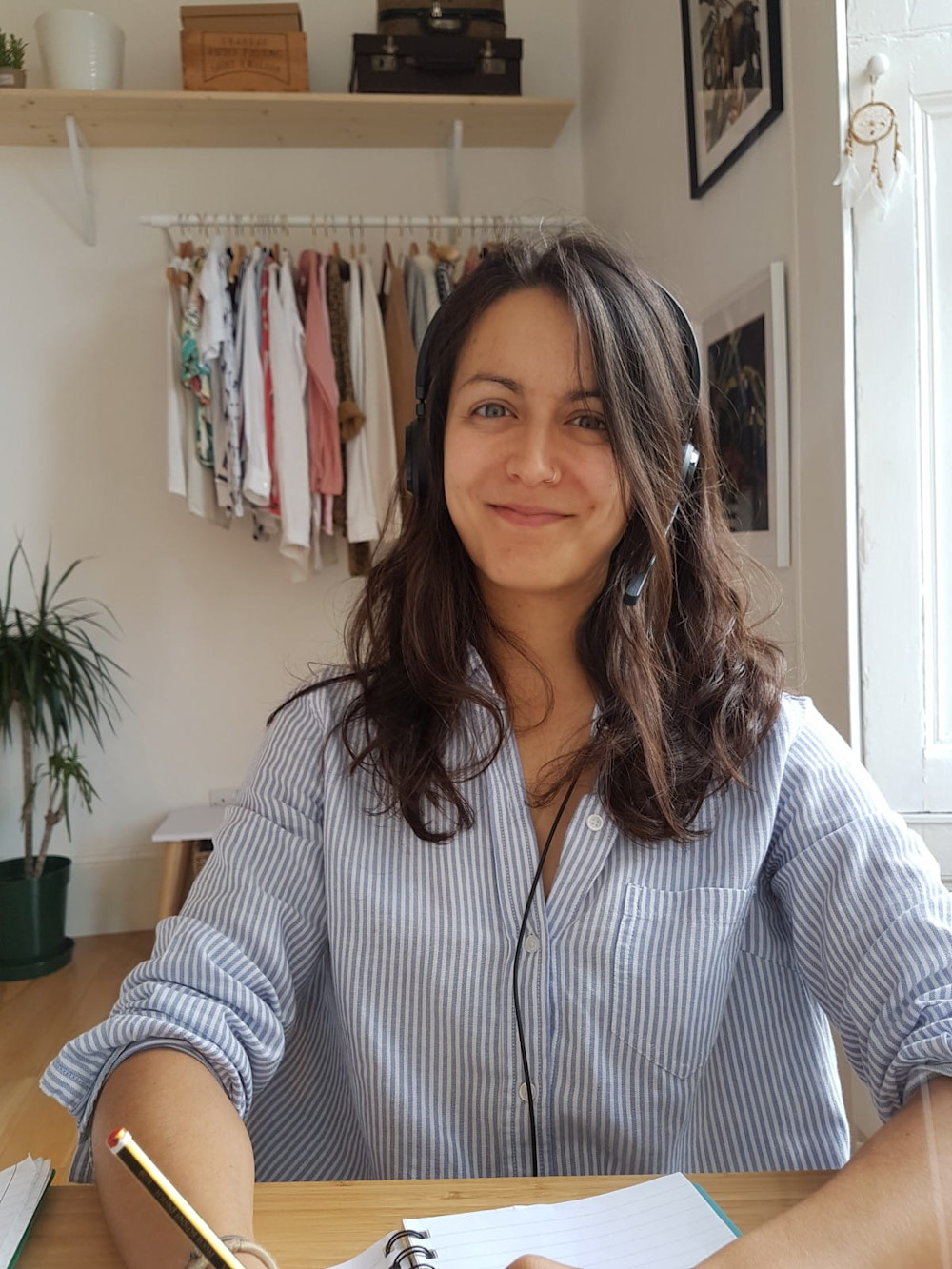 One of our helpline advisers, wearing a telephone headset and smiling