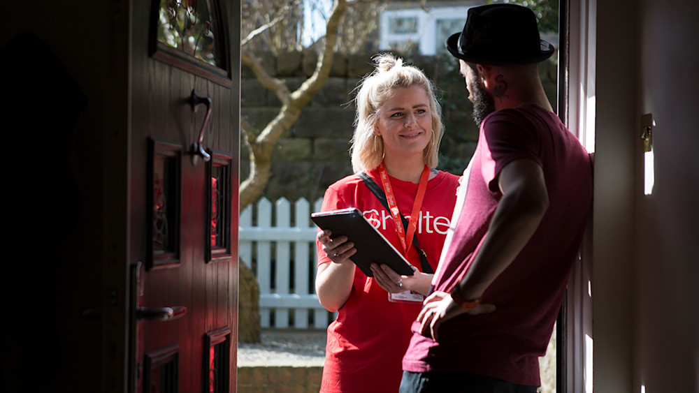 Shelter campaigner at front door with petition