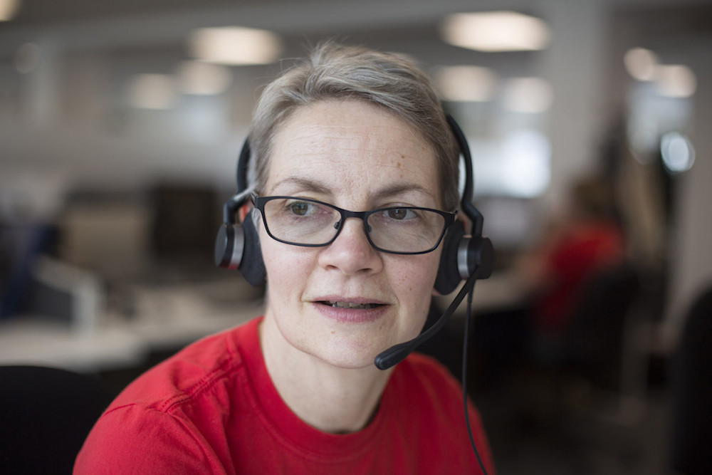 A Shelter helpline advisor wearing a headset