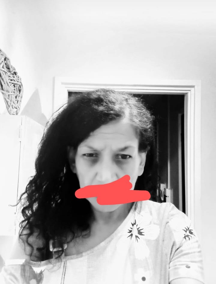 Tracy, Shelter Peer Researcher, has a red pen mark on her mouth.