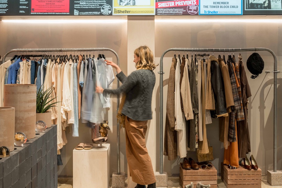 A sales assistant hangs clothes at our King's Cross Boutique