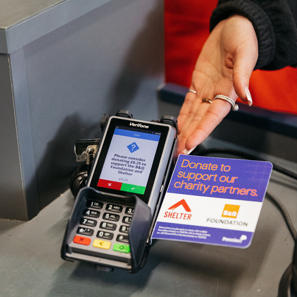 A card reader at a B&Q shop till shows how donations of pennies can help Shelter