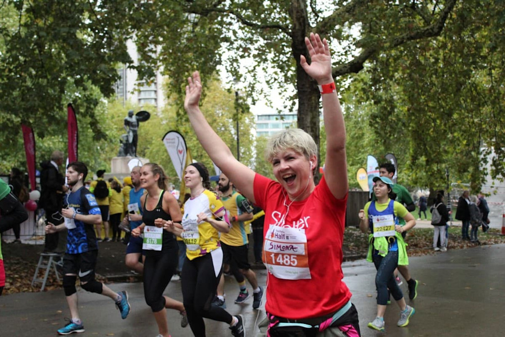 A woman with cropped blonde hair running the Royal Parks Half Marathon