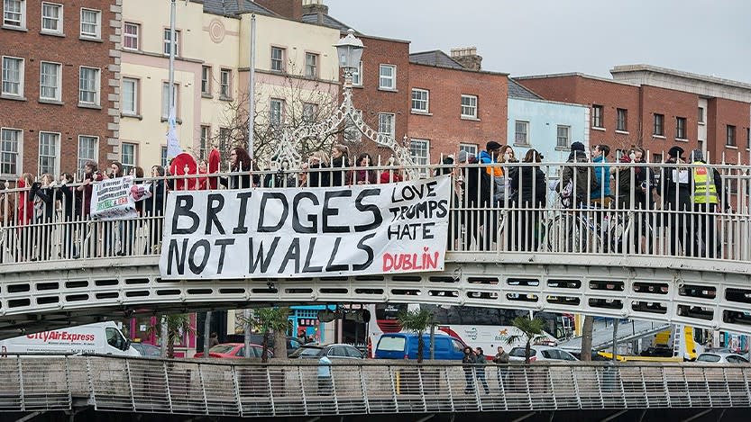 A banner drop in Dublin, Ireland. The banner slogan reads 'Bridges not walls'.