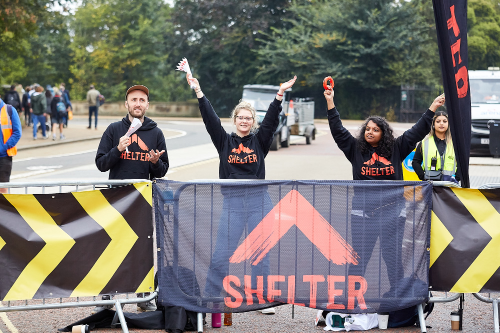 Shelter supporters cheer on runners from the side of the route