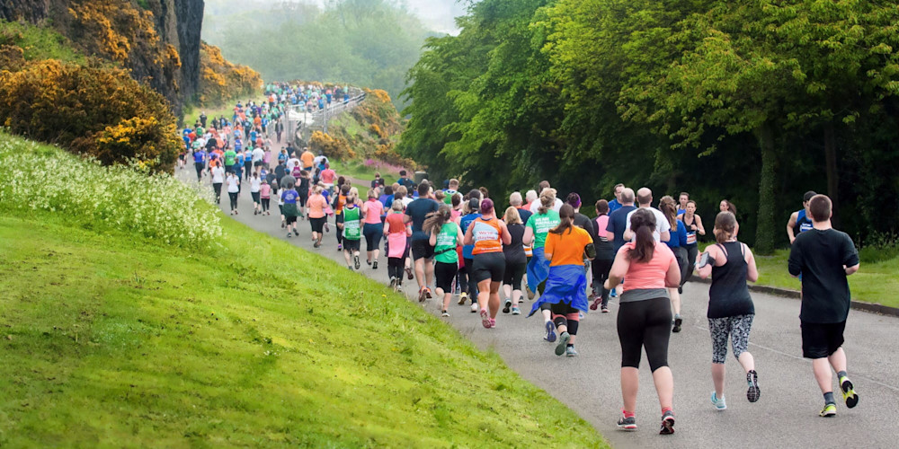 A stream of runners jog through the countryside outside Edinburgh