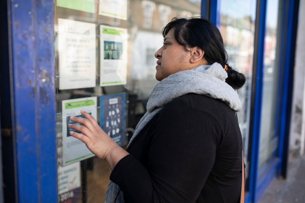 Woman looking at property ads