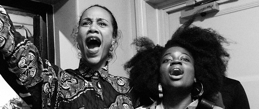 Black and white historical image of two women with raised voices