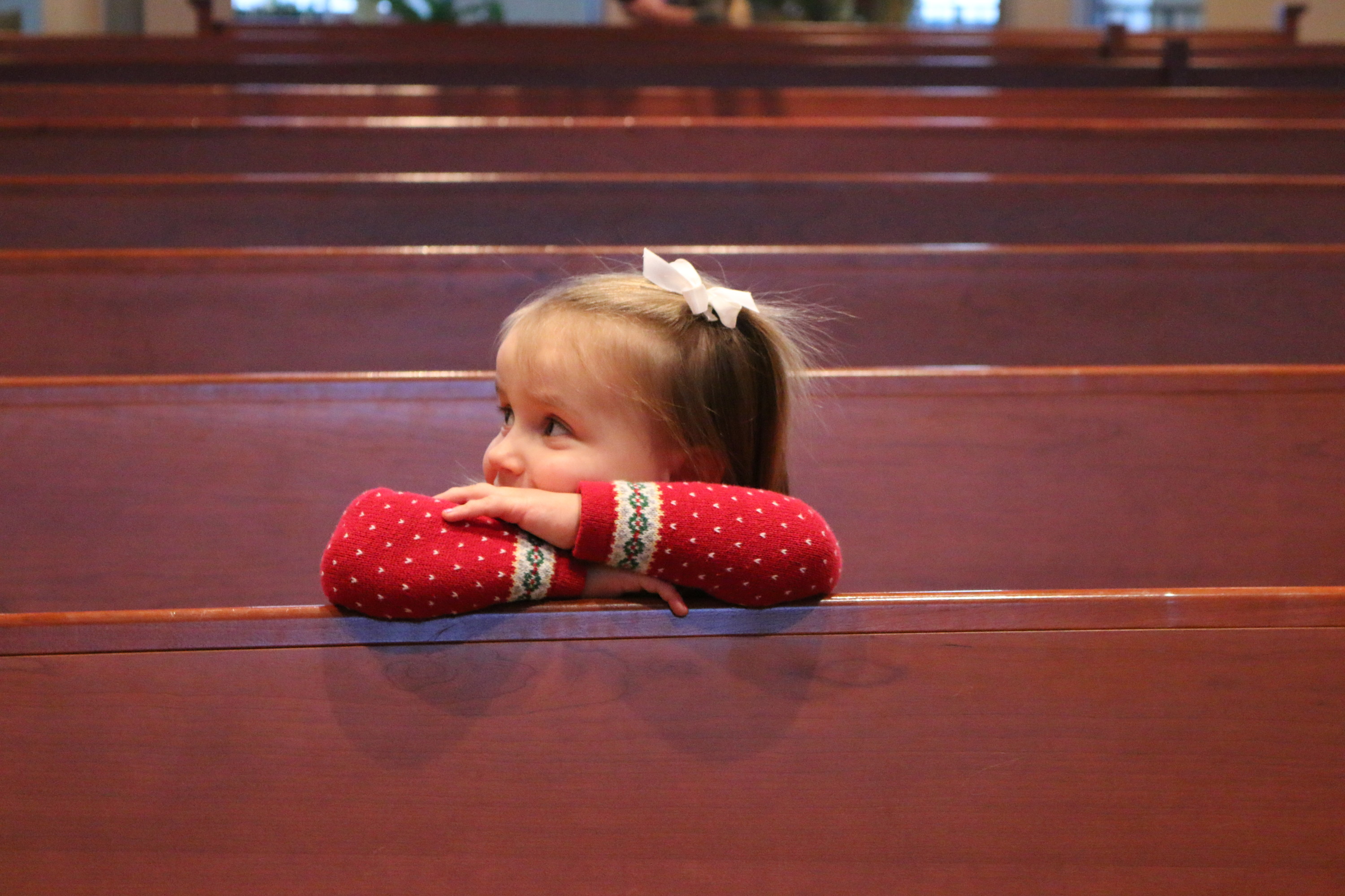 Young girl on a pew