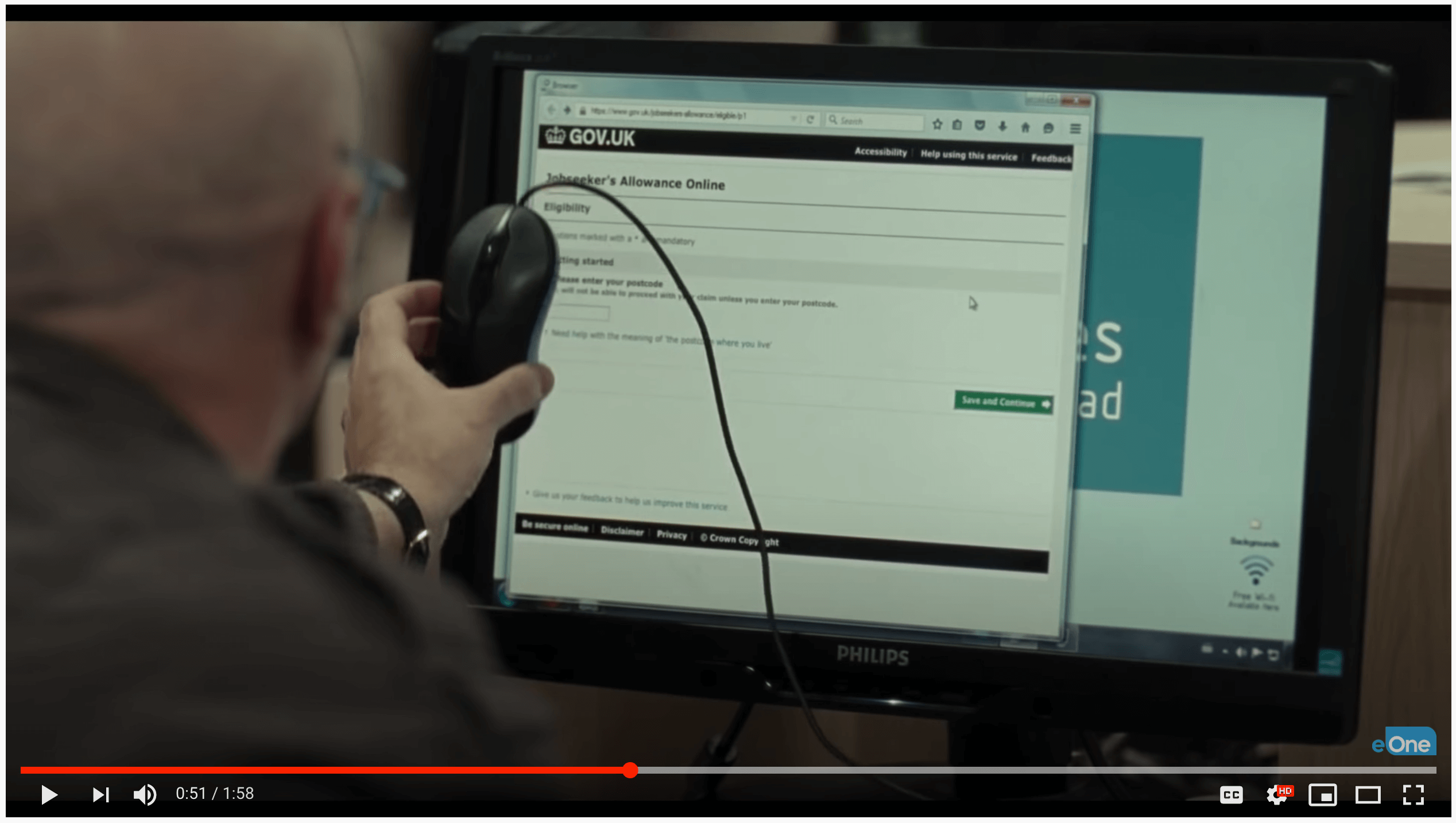A screenshot of the trailer for the movie I, Daniel Blake on YouTube, showing Daniel Blake trying to use a computer to apply for support.