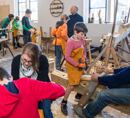 A children’s spoon carving workshop underway at the Rekindle workshop, at Te Matatiki Toi Ora Arts Centre, Christchurch – Rekindle is a recipient of a 2019 Arts Grant. Image: Johannes van Kan.