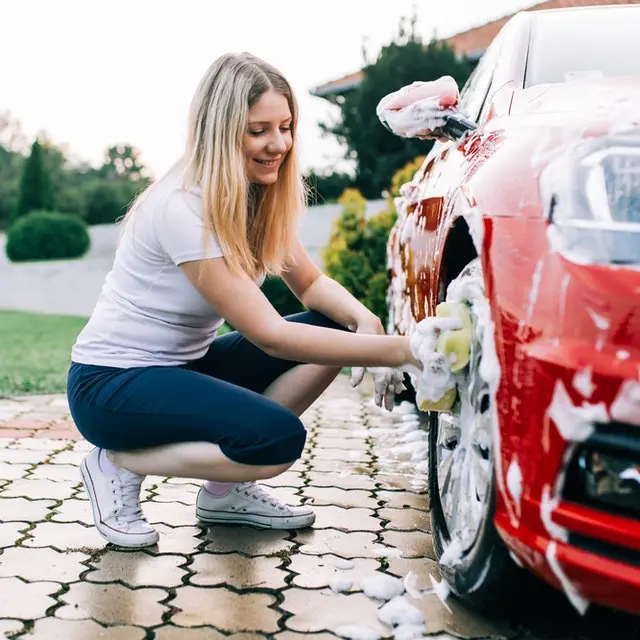 Woman washing red car