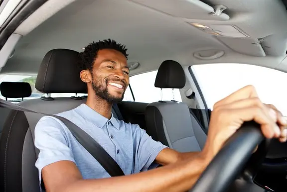 Smiling man driving a car