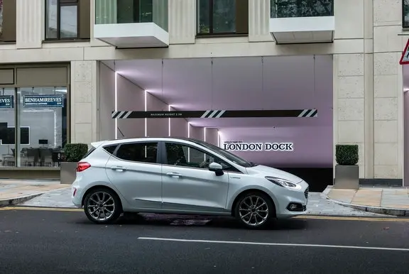 The side exterior of a white Ford Fiesta