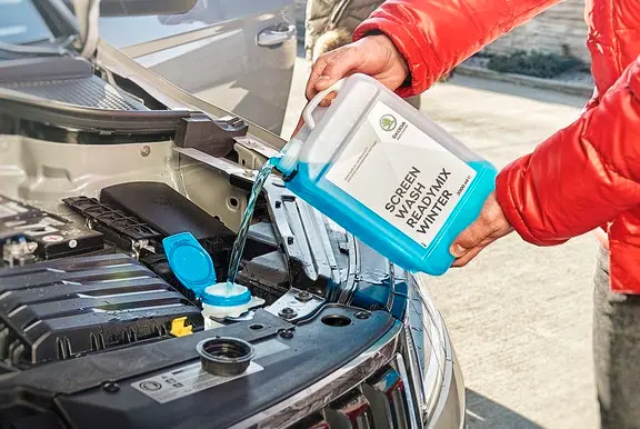 Screen wash being poured into a car