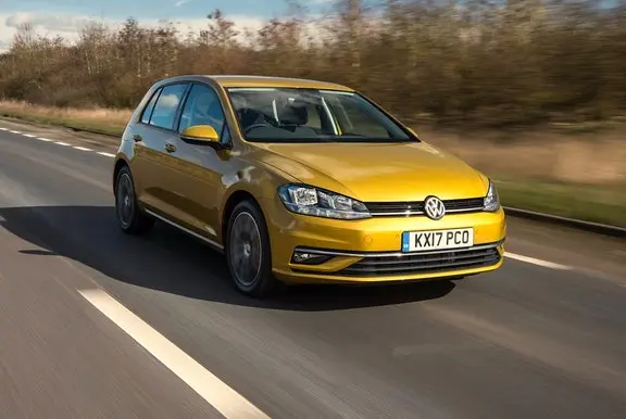 The front exterior of a gold Volkswagen Golf