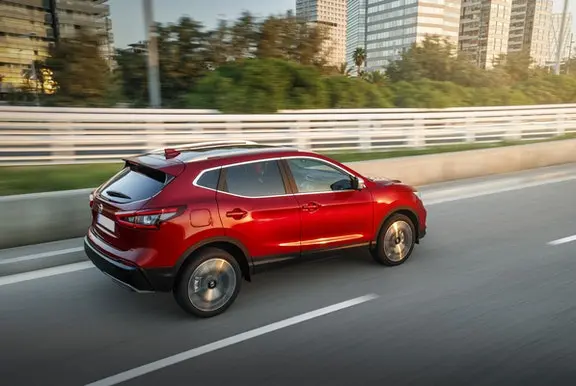 The rear exterior of a red Nissan Qashqai