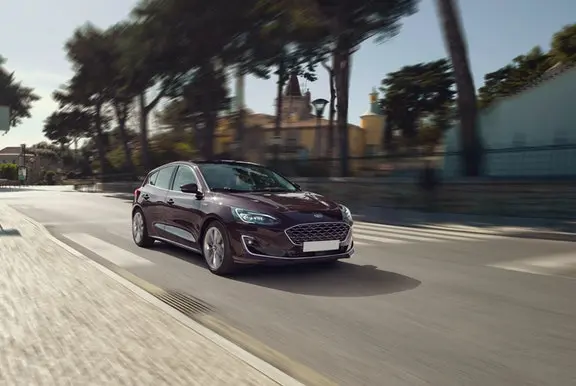 The front exterior of a brown Ford Focus