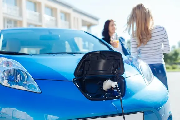 Blue electric car being charged