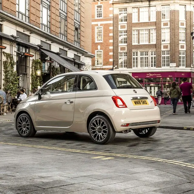 White Fiat 500 driving through town
