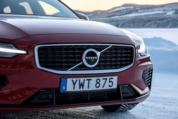 Close up of the front of a Volvo on snow