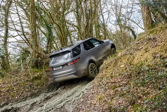 Land Rover Discover going off road up a hill