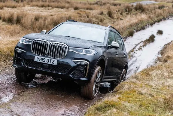 Black BMW X7 driving off-road