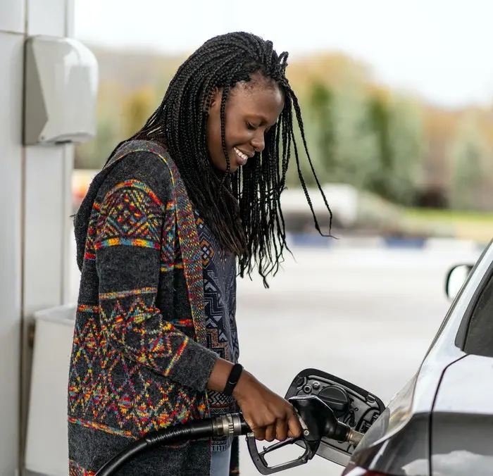 Lady at fuel pump filling up her car