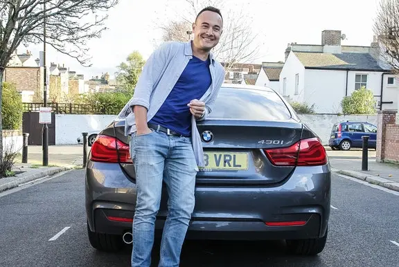 A Cazoo customer smiling with his new car
