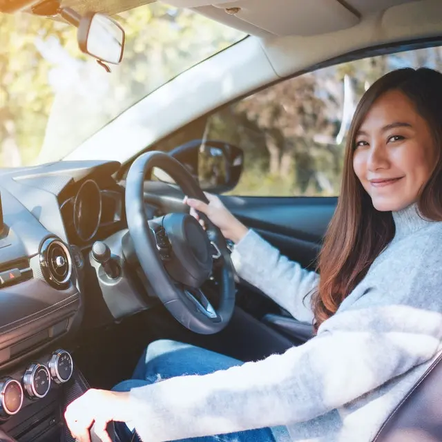 Smiling woman driving a car