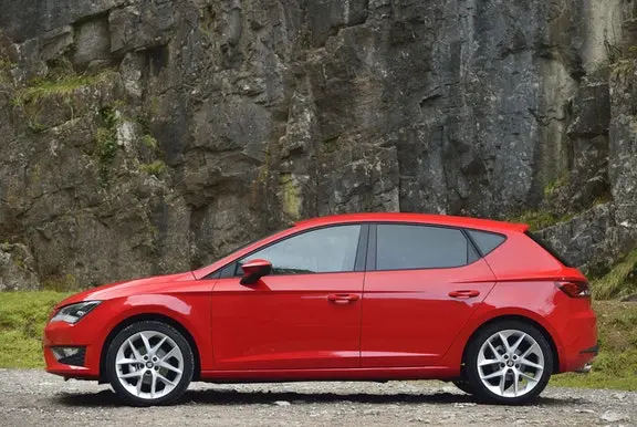 The side exterior of a red Seat Leon