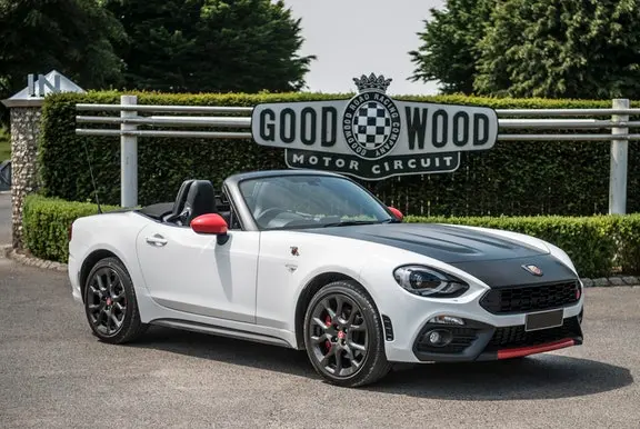 The front exterior of a white Abarth 124 Spider