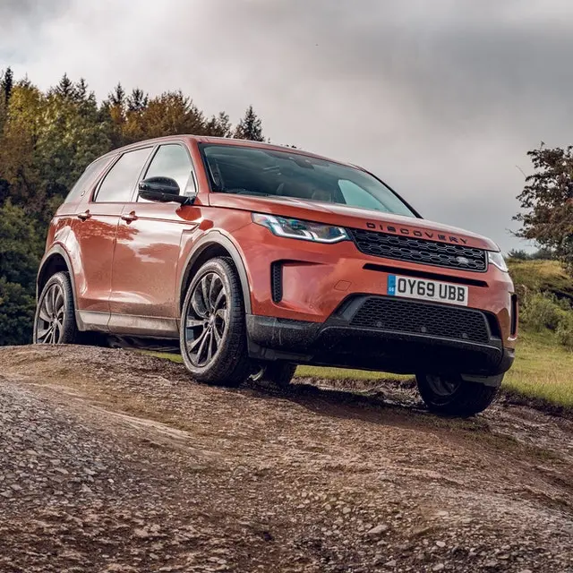 A red Land Rover parked