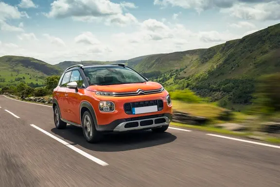 The front exterior of an orange Citroen C3 Aircross