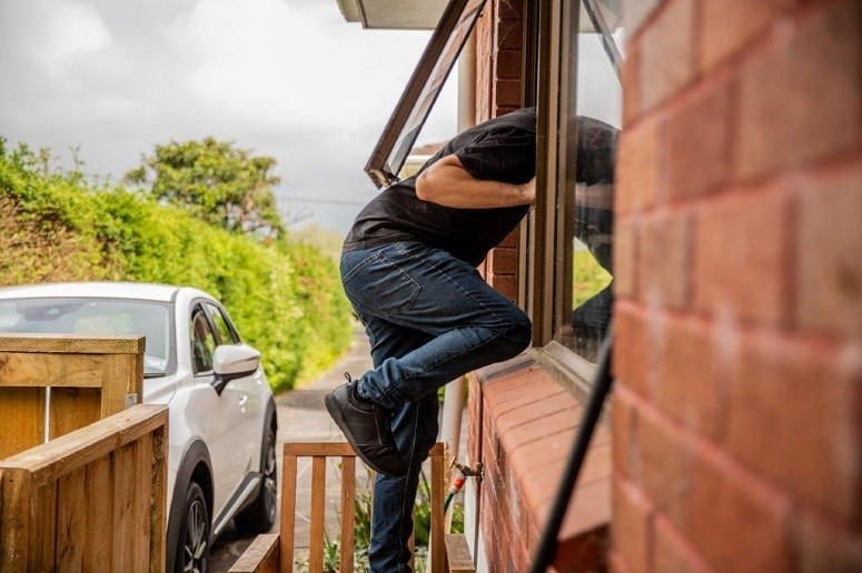 Man getting through window