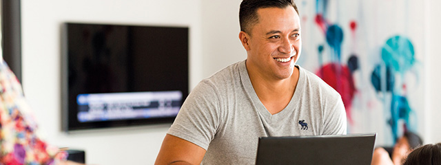 Man using a laptop in a living room