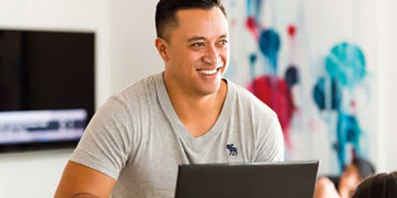 Man using a laptop in a living room