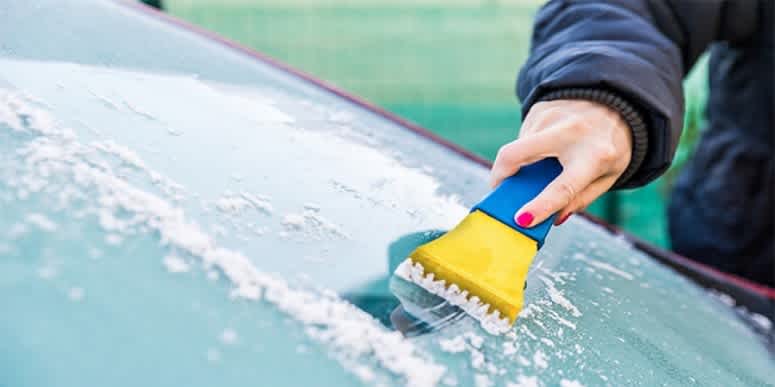 Remove ice from car glass with a plastic ice scraper.