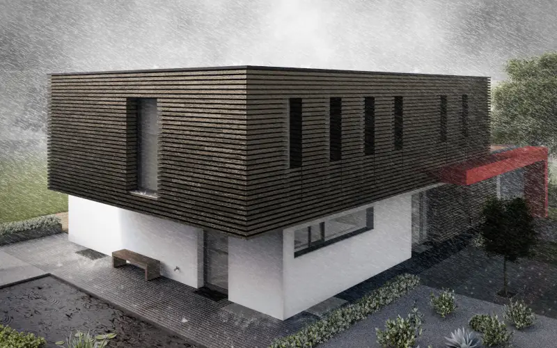 modernes Haus mit Putz- und Holzfassade bei Starkregen