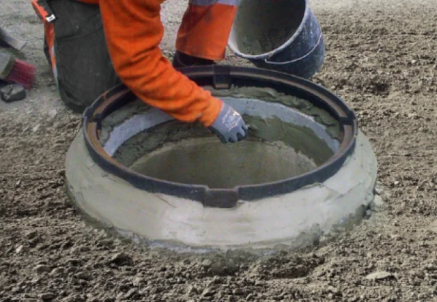 Arbeiter dichtet Schachtring ab