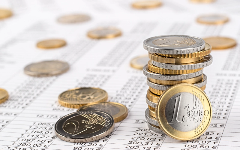 Finanzen Unternehmensrechnung Bestandshintergrund mit Stapel von Euro-Münzen auf Datenblatt