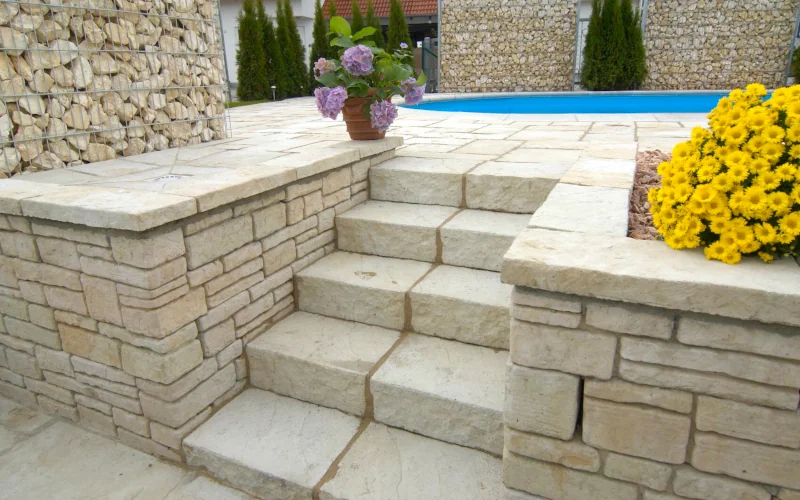Terrassenbereich mit Pool und Treppe aus Sandstein