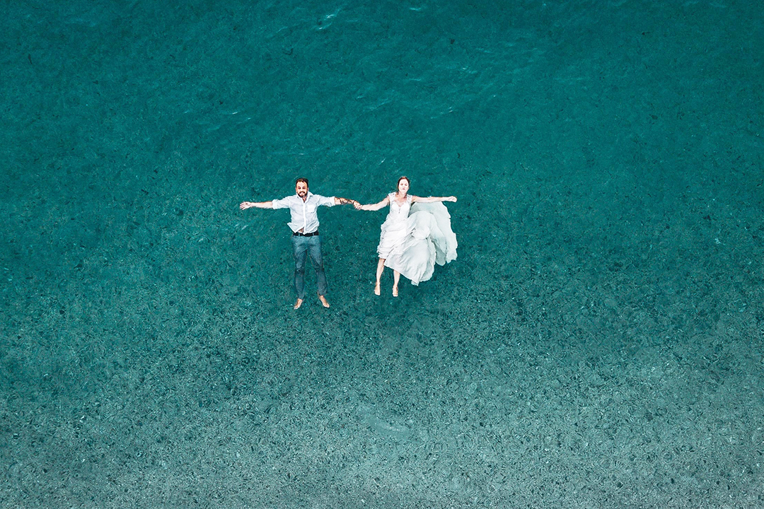 couple floating in ocean
