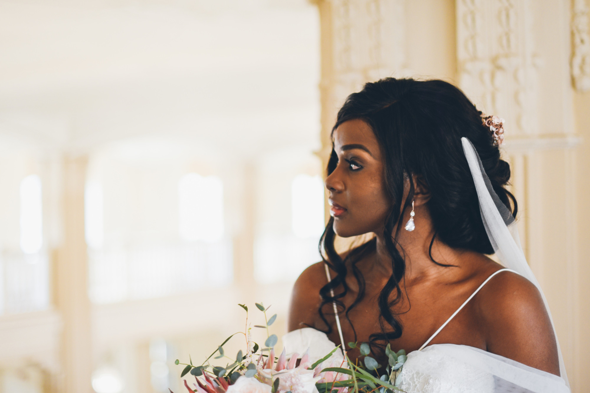 African-American bride side pose with beautiful hair curls