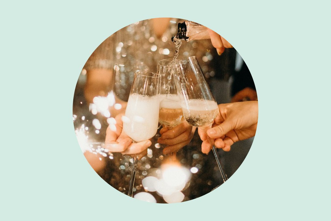 Circular image of friends toasting with champagne glasses and sparkling lights
