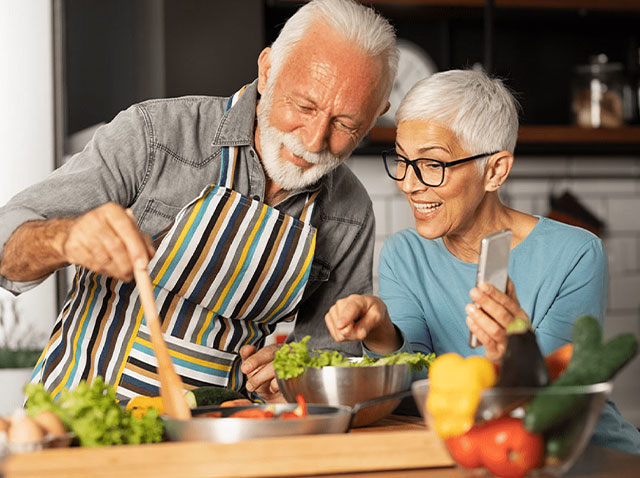 Couple âgé cuisinant dans la cuisine