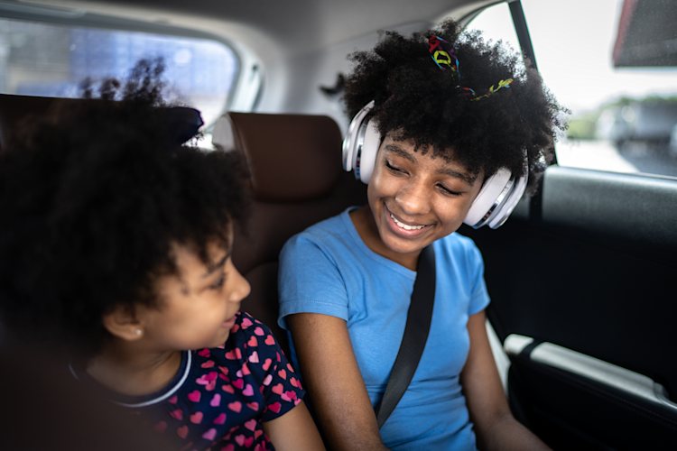 Siblings in backseat of car
